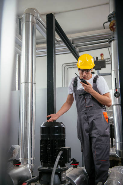 istock Repairmen in boiler room checking pressure 1074888158