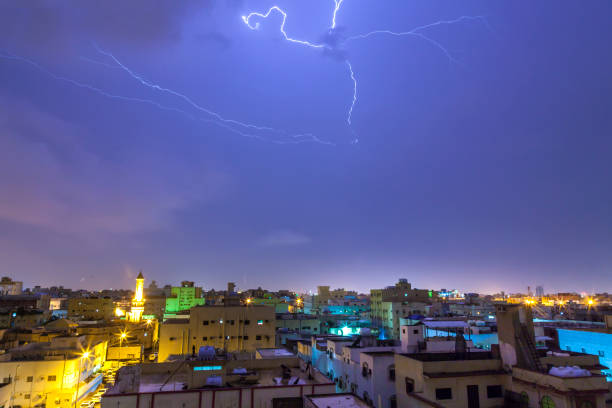 Lightning storm over city in purple light in jeddah al marwah Lightning storm over city in purple light in jeddah al marwah saudi arabia jeddah landscape stock pictures, royalty-free photos & images