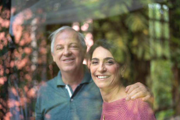 istock Senior Couple Looking Through Window - Portrait 1074893152