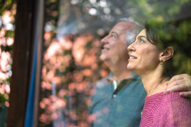 istock Senior Couple Looking Through Window - Portrait 1074893162