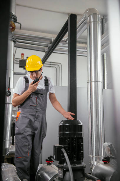 istock Repairmen in boiler room checking pressure 1074894050