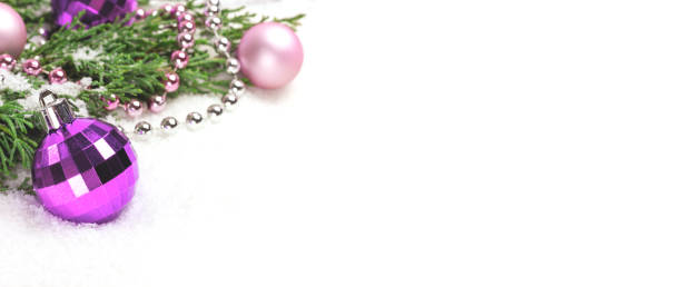 istock Christmas baubles and evergreen branches on white. 1074895102