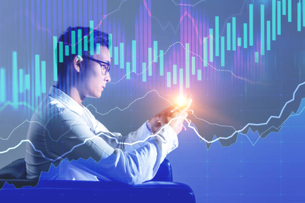 istock Asian businessman in armchair, forex graphs 1074898476