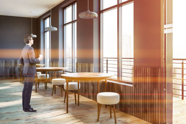 istock Gray cafe interior, round tables, man 1074899216