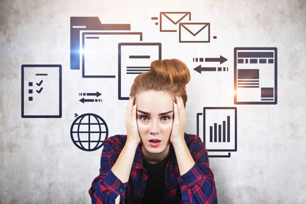 Stressed teen girl and web documents, concrete Stressed young woman in checkered shirt sitting near concrete wall with electronic documents and internet icons. Concept of information overload. Toned image information overload photos stock pictures, royalty-free photos & images