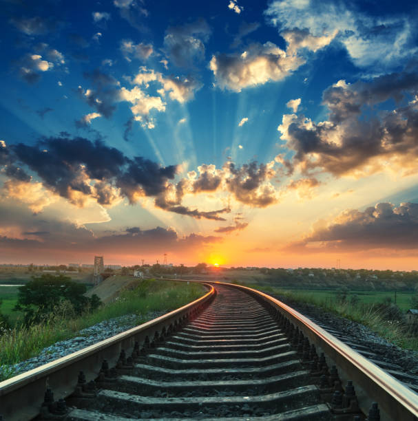 istock good sunset in clouds over railroad 1074901496