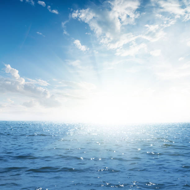 istock sunset in blue sky with clouds over sea 1074903490