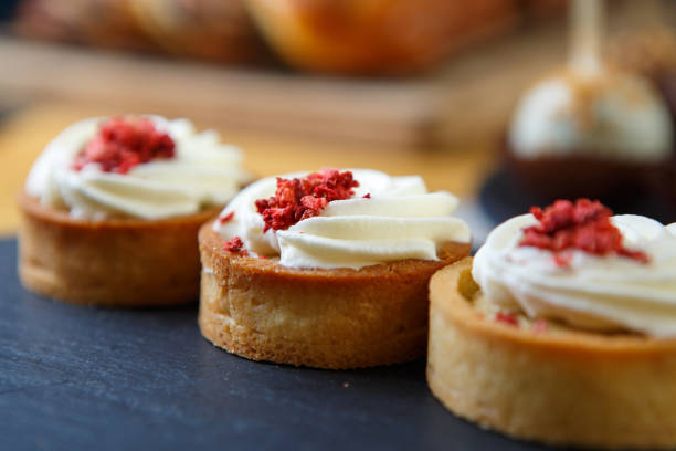 istock Delicious white creamy cupcakes in cafe 1074909754