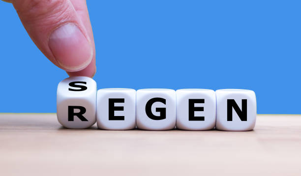 istock Hand is turning a dice and changes the german word 