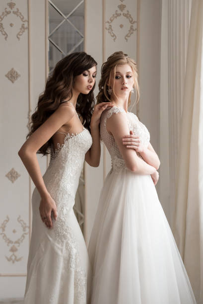 istock Two girls models in wedding dresses. 1074910690