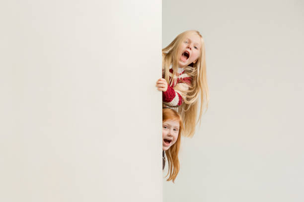 istock Banner with a surprised children peeking at the edge 1074911070
