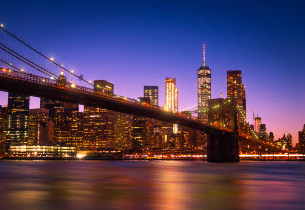 istock Illuminated Bridge Over River Against Buildings At Night 1074911230