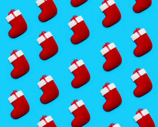 istock Pattern made with Christmas Red Socks on Blue Background.  Creative Minimal Holiday Composition. Flat Lay 1074915200