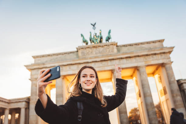 istock Two Friends at Brandeburg Gate in Berlin take a selfie 1074918976