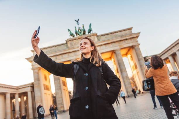 istock Two Friends at Brandeburg Gate in Berlin take a selfie 1074919082