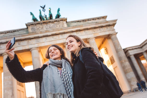 istock Two Friends at Brandeburg Gate in Berlin take a selfie 1074919224