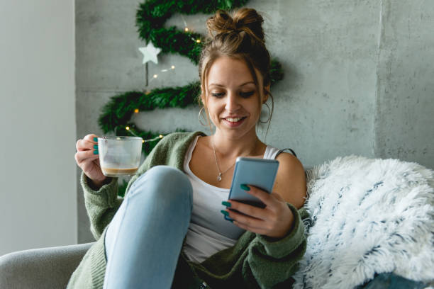 istock Smiling woman looking at mobile phone 1074923528