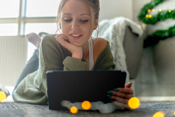 istock Young woman looking at digital tablet 1074924796