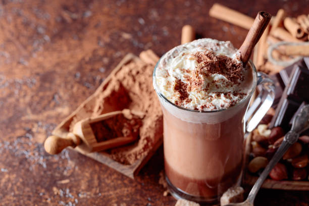istock Cocoa with cream, cinnamon, chocolate pieces and various spices. 1074925930