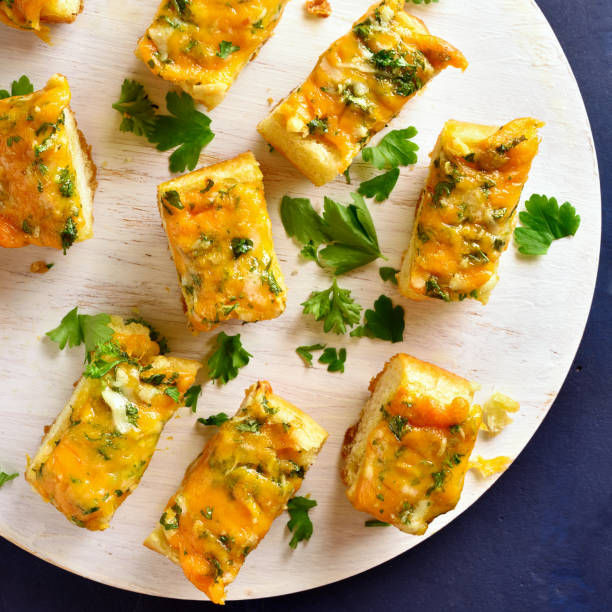 istock Cheese and garlic bread with greens 1074926416