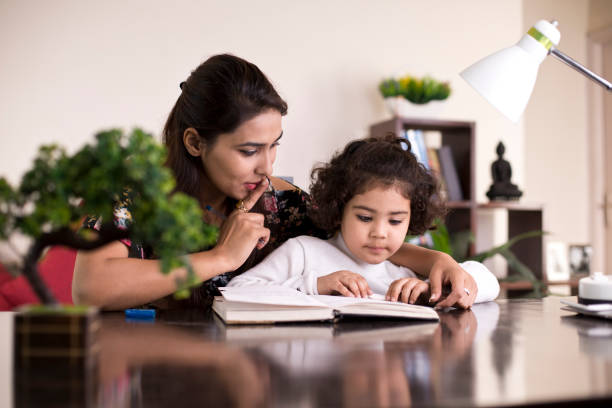 istock Mother helping daughter with homework 1074933770