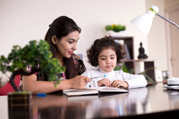 istock Mother helping daughter with homework 1074934212