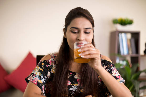 istock Woman drinking juice 1074936850