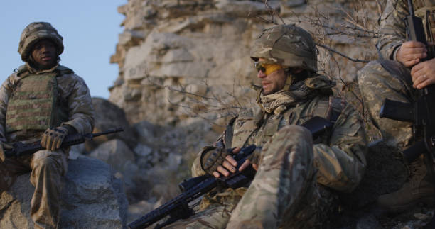 istock Armed soldiers checking their equipment 1074937126