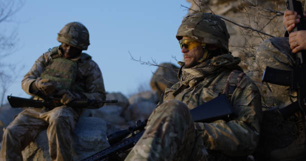 istock Armed soldiers checking their equipment 1074937220