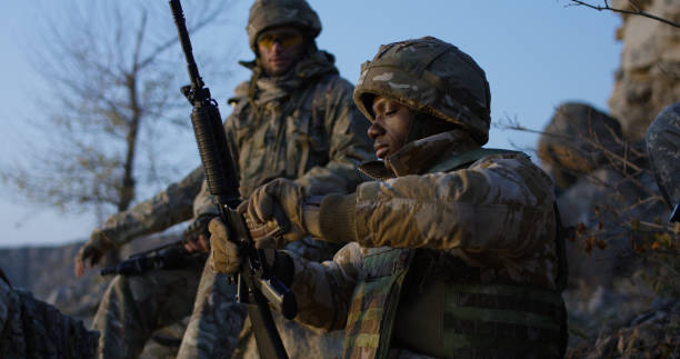 istock Soldiers sitting during a break in an assault 1074937224