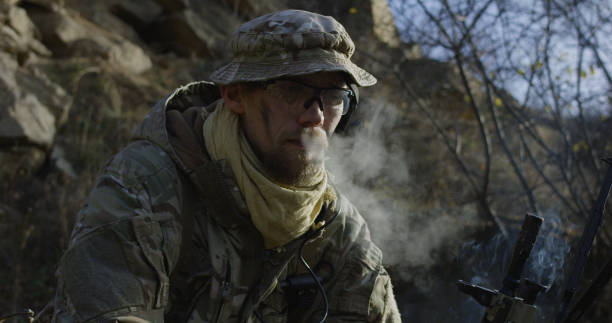 istock Soldier taking a break and smoking 1074937380