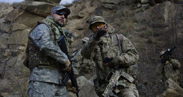 istock Armed soldiers reviewing a map 1074937408
