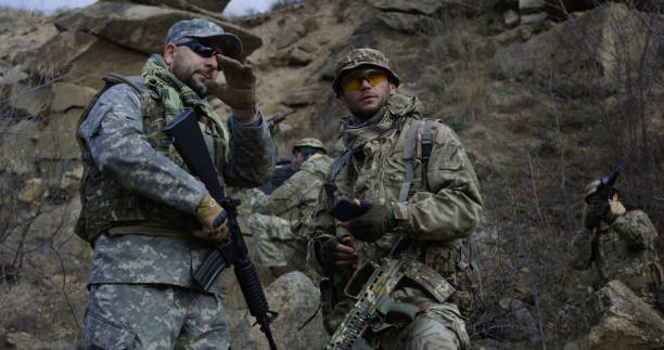 istock Armed soldiers reviewing a map 1074937410