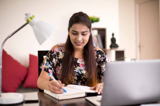 Woman writing book at home