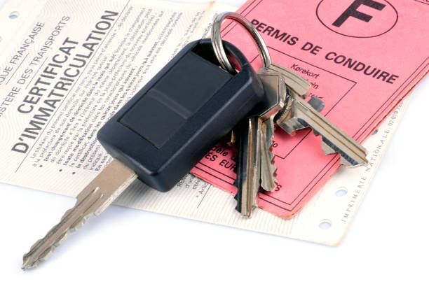 istock Car key on a driver's license and registration certificate 1074938664