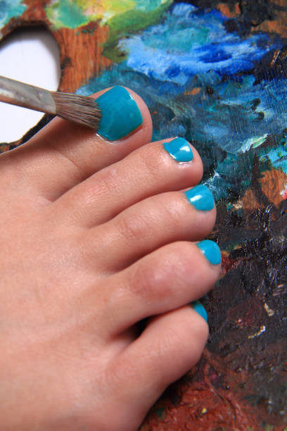 istock women feet and colors (pedicure background) 1074941534