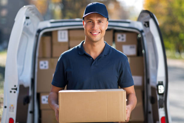 Delivery man Delivery man standing in front of his van delivery person stock pictures, royalty-free photos & images