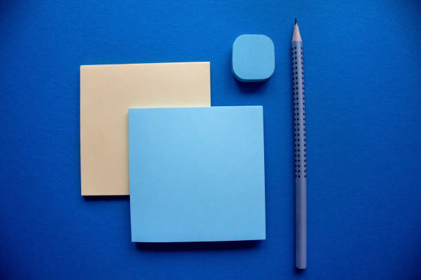 istock Blue and yellow stiker blocks with a pencil and eraser. 1074948626