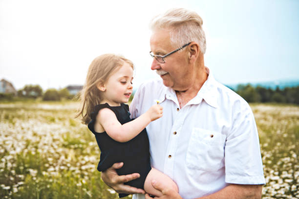 istock grandfather spending time with little child during the sunset. 1074949510