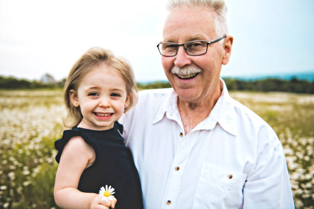 istock grandfather spending time with little child during the sunset. 1074949524
