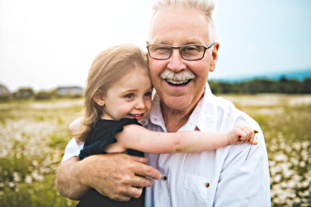 istock grandfather spending time with little child during the sunset. 1074949556