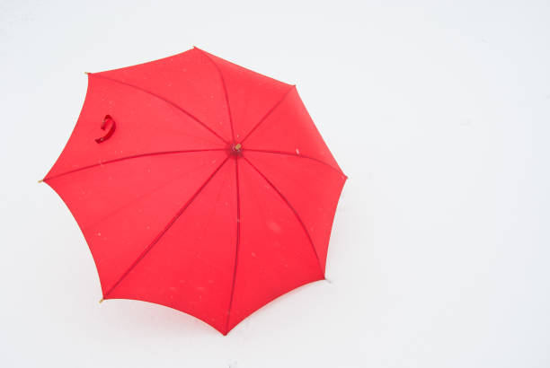 istock Single red umbrella on the snow 1074955910