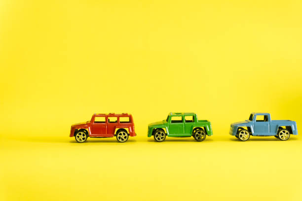istock red,green and blue car on yellow 1074958768