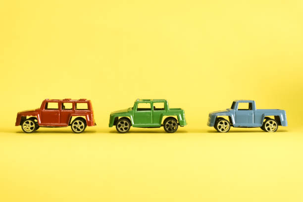 istock red,green and blue car on yellow 1074958782