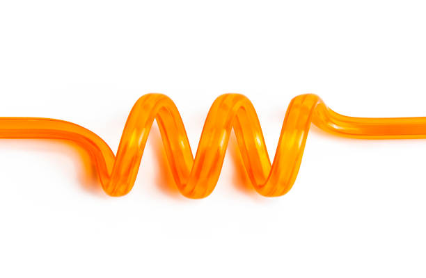 Orange colored spiral pipette close-up. Orange colored spiral pipette close-up. the twist stock pictures, royalty-free photos & images