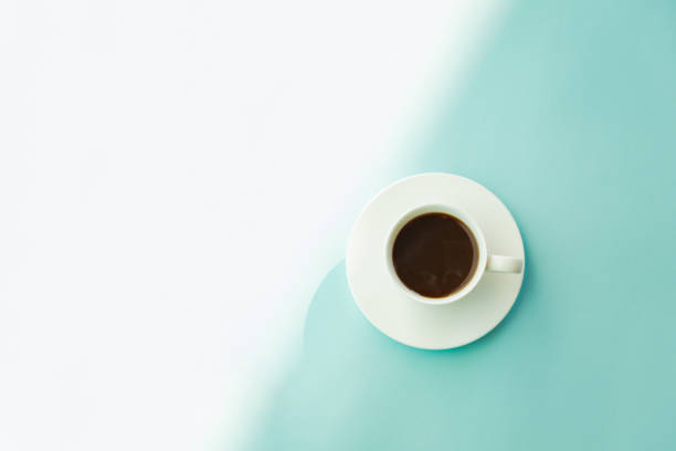 istock Cup of steaming coffee on seafoam green table, top view 1074967296
