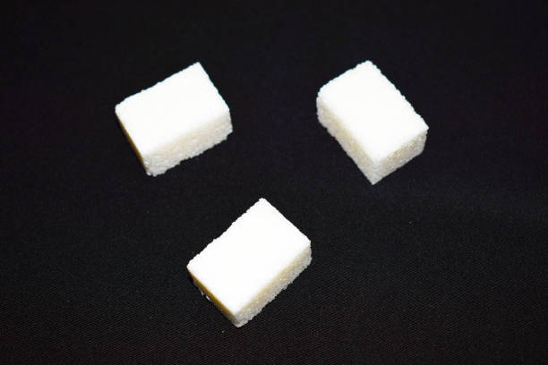 istock Sugar cubes, on a black background, isolated. 1074972126
