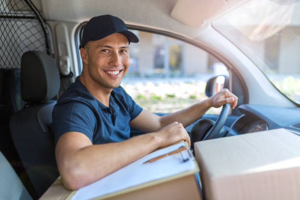 istock Delivery man sitting in a delivery van 1074974368