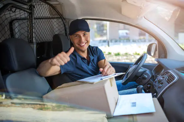 Photo of Delivery man sitting in a delivery van