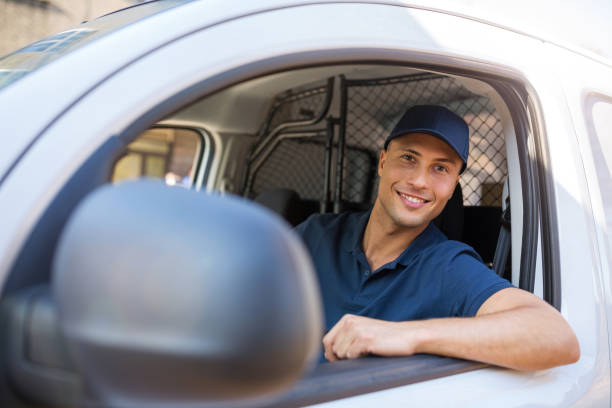 istock Delivery man sitting in a delivery van 1074974642